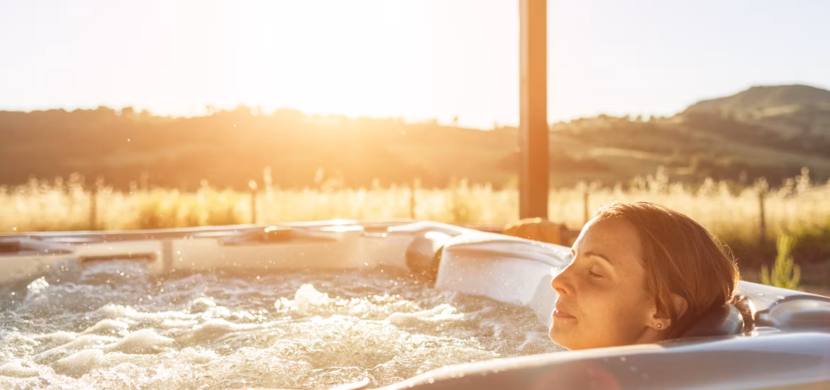 1737559451-woman-relaxing-in-the-spa-s-back-shiatsu-seat Woman relaxing in a hot tub using built-in back shiatsu massage jets