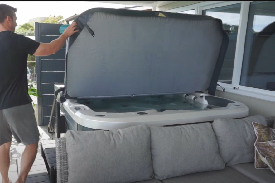 Clean Hot Tub Cover Opening and cleaning a hot tub cover on an outdoor patio