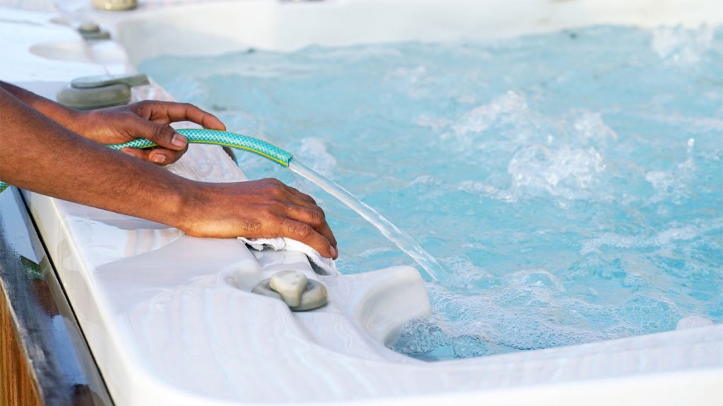 refilling hot tub Refilling a hot tub with fresh water using a garden hose